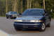 1978 Dodge Monaco - A blue and silver sedan, likely from the 1990s, is parked on a road with another car in the background.