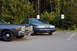 1978 Dodge Monaco - Two cars are parked in a lot, with trees and signs visible behind them.