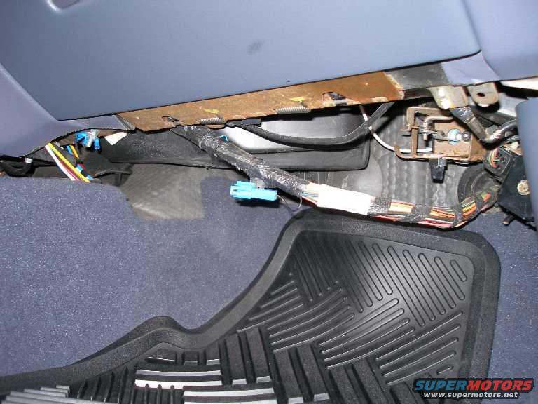 before.jpg What the passenger side footwell looked like before installing the courtesy lamp and panel.

Note the blue connector for "dark car mode".