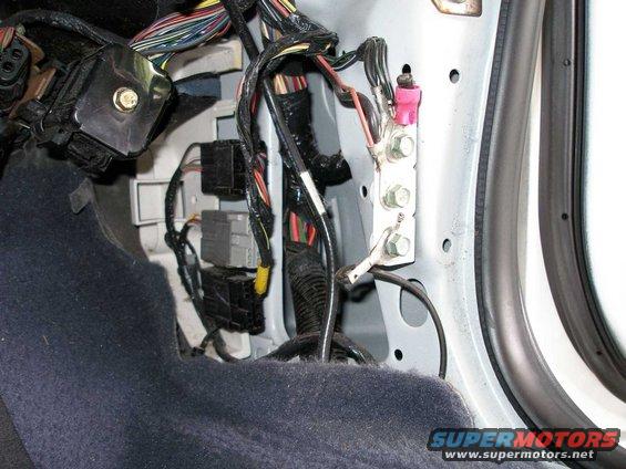 Note the clipped grounds from formerly installed emergency equipment. 

The dome light wire is in the wiring bundle at the top of the picture.