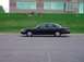 1998 Ford Crown Victoria - Side profile of a black 1998 Ford Crown Victoria sedan parked on asphalt.