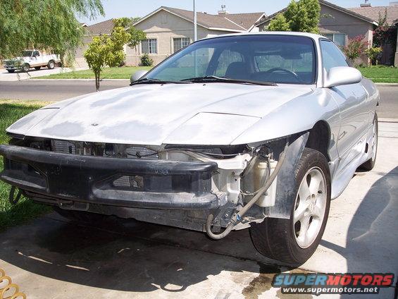 1993 Ford Probe front end with bumper removed, showing exposed radiator and wiring