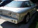 1993 Ford Probe - The rear of a white 1993 Ford Probe coupe is shown, with its bumper removed and taillights missing.