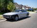 1993 Ford Probe - A silver 1993 Ford Probe sits on the street with its front bumper removed, while another SUV is parked in the driveway behind it.