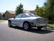 1993 Ford Probe - A silver 1993 Ford Probe is seen from the rear, with its bumper removed, parked on a residential street.