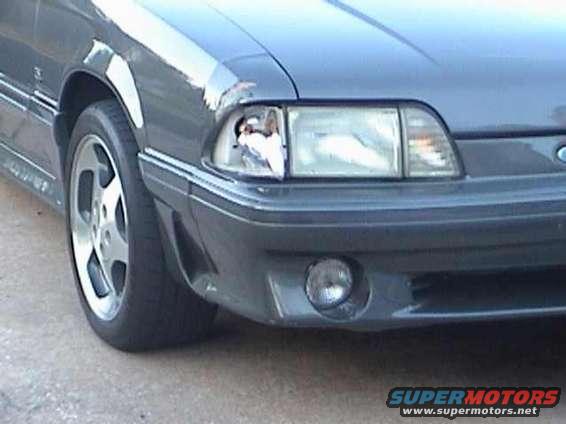 Gray 1989 Ford Mustang front corner with damaged headlight