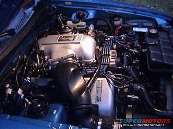 Engine bay with silver intake manifold and black hoses