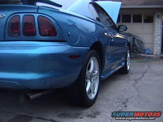 Blue convertible Mustang rear quarter panel and side profile, hood open