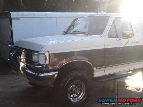 1989 Ford Bronco parked next to a trailer