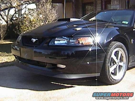 Black Ford Mustang with hood scoop and aftermarket wheels