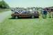 1970 Ford Ranchero - A two-tone station wagon is displayed at an outdoor car show with other vehicles and people in the background.
