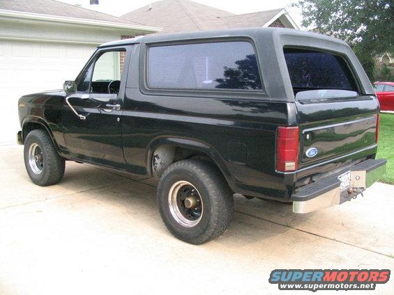 Black Ford Bronco parked on a driveway, rear quarter view