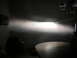 1996 Toyota 4Runner - A bright headlight beam pattern is cast onto a wall, illuminating the room and a table below.
