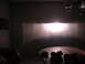 1996 Toyota 4Runner - A bright headlight beam pattern is projected onto a wall in a dimly lit room.