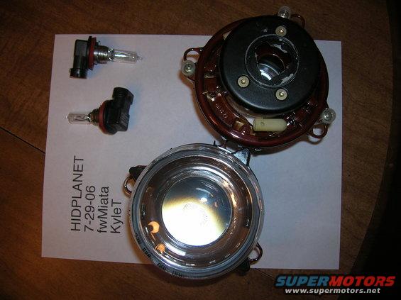 Fog light assembly and two bulbs on paper with text