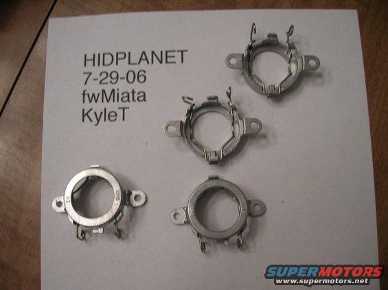 Four metal headlight adapter rings laid out on a paper with text