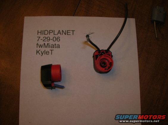 Two red and black automotive electrical connectors with wires on a piece of paper labeled HIDPLANET 7-29-06 fwMiata KyleT
