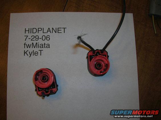 Two red HID headlight connectors with wires on a piece of paper. Text on paper says HIDPLANET 7-29-06 fwMiata KyleT