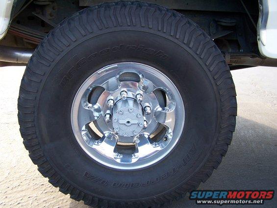 Close-up of a BFGoodrich All-Terrain T/A tire on a chrome wheel with a hubcap