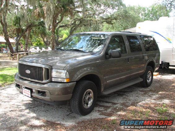 2003 Ford Excursion parked next to a trailer, front 3/4 view