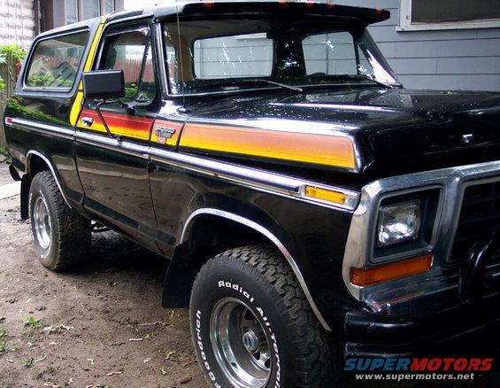 Black Ford Bronco with orange and yellow stripe decals on the side