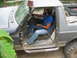 1992 Ford Mustang - A man is seen driving a heavily modified off-road vehicle, equipped with a snorkel for deep water crossings.