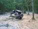 1992 Ford Mustang - Modified off-road vehicle navigates a challenging rocky trail in a forest setting.
