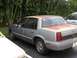 1991 Oldsmobile Calais - Side angle view. That rust gets worse with every picture.