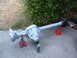 1994 Jeep YJ - Rear axle assembly supported by jack stands outdoors, ready for work.