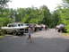 1995 Ford C-350 (Centurion Conversions) - Multiple trucks and SUVs are parked in a line outdoors, with people milling around.