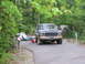 1995 Ford C-350 (Centurion Conversions) - A Ford Bronco sits parked at a campsite with tents and camping gear nearby.