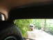 1995 Ford C-350 (Centurion Conversions) - Pickup truck driving on a dirt road surrounded by trees.