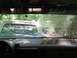 1995 Ford C-350 (Centurion Conversions) - Looking through the windshield at a line of trucks, one with a sticker reading 'In memory of Tim Kran'.