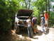 1995 Ford C-350 (Centurion Conversions) - Group of people examining the engine of a lifted 1995 Ford C-350 off-road truck.