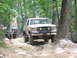 1995 Ford C-350 (Centurion Conversions) - Ford Bronco navigates a challenging off-road trail with another vehicle following.