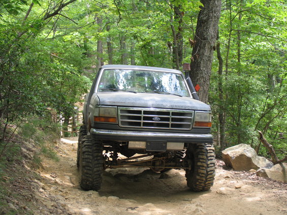 1995 Ford C-350 (Centurion Conversions) front view, lifted, on dirt trail