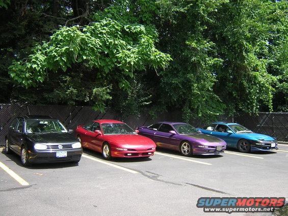 Red Ford Probe parked in a lot, front 3/4 view. Visible damage to front bumper