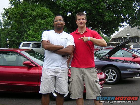 Red 1995 Ford Probe side view with hood open, two men standing nearby