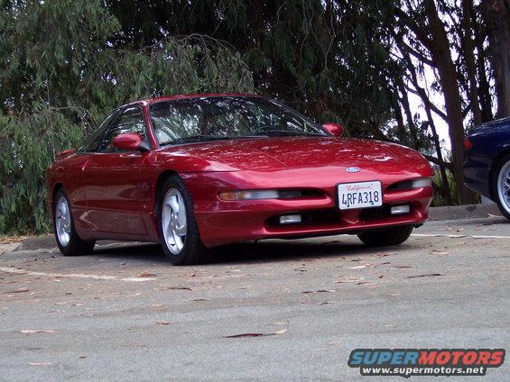 Red 1995 Ford Probe parked on asphalt, front 3/4 view, California license plate 4RFA318 visible