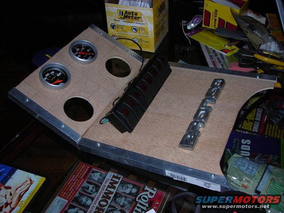 Custom dashboard panel with two gauges, a switch bank, and a chrome 'BRONCO' emblem