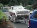 1955 Ford F-100 - White Ford Bronco on a trailer, front end removed, with "Project for Sale" signs on windshield.