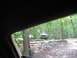 1995 Ford C-350 (Centurion Conversions) - A white truck is parked on a dirt path surrounded by trees and fallen logs.