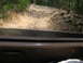 1995 Ford C-350 (Centurion Conversions) - Driving an off-road trail with many rocks and uneven terrain.