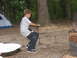 1995 Ford C-350 (Centurion Conversions) - A young boy sits on a stone wall near a tent in a forest setting.