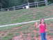 1995 Ford C-350 (Centurion Conversions) - A young girl with braided hair waves happily while standing on a grassy slope.