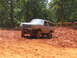 1995 Ford C-350 (Centurion Conversions) - Ford Bronco navigating a muddy off-road course with lifted suspension.