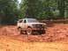 1995 Ford C-350 (Centurion Conversions) - Ford Bronco tackles a muddy trail during an off-road event.