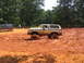 1995 Ford C-350 (Centurion Conversions) - Off-road Bronco struggling in thick mud during an event.