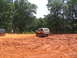 1995 Ford C-350 (Centurion Conversions) - Two SUVs are parked in a muddy, wooded area.
