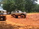 1995 Ford C-350 (Centurion Conversions) - This lifted SUV is stuck deep in the mud during an off-road event. Another vehicle is visible to the left.
